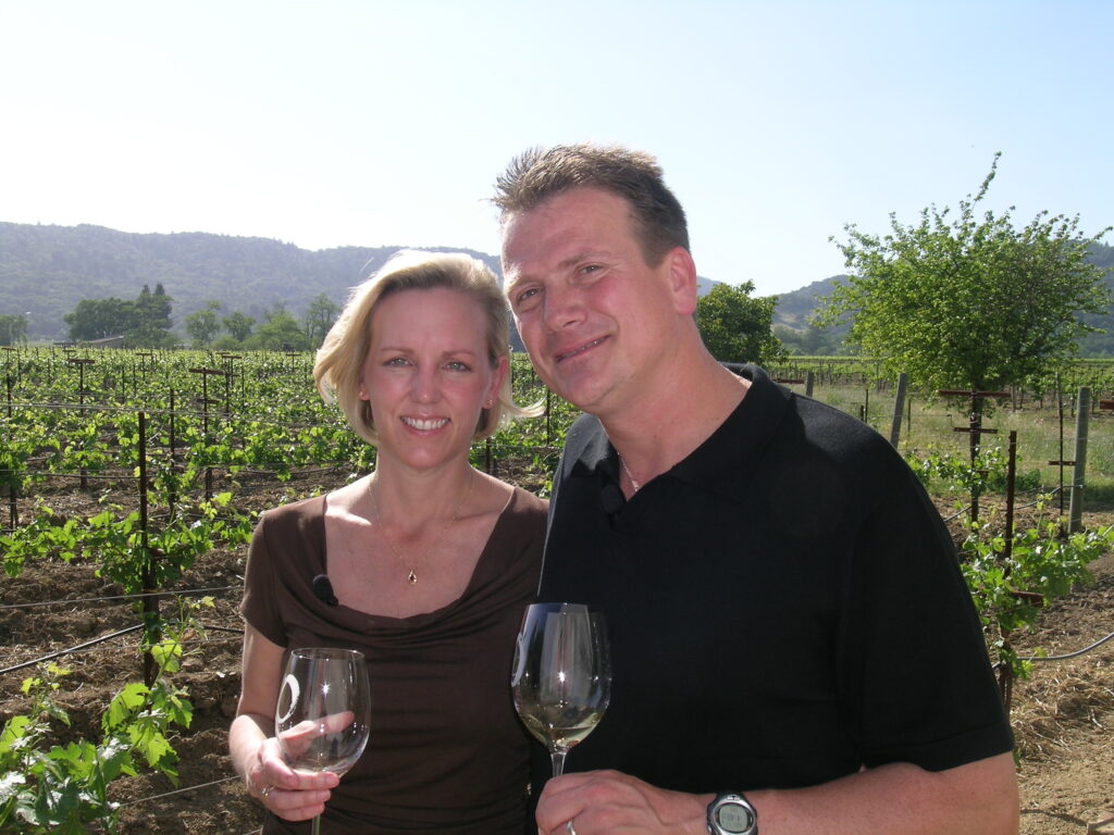 Anniversary couple in front of vineyard