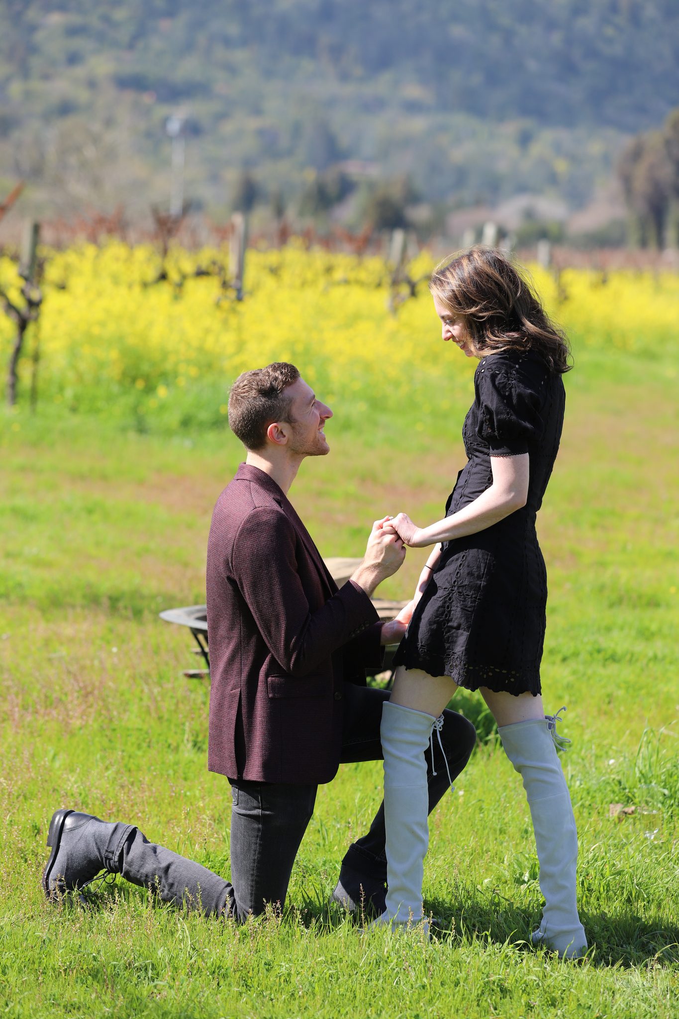 A man on one knee proposing in the vineyard at O'Brien Estate