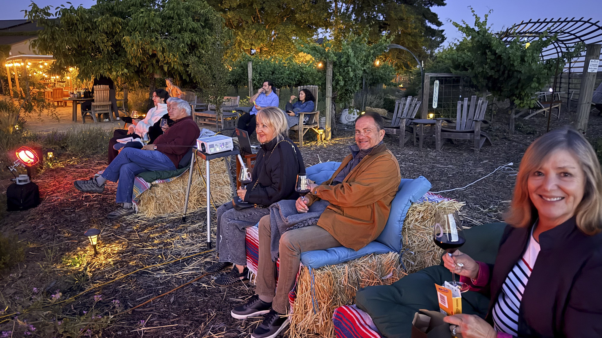 Couples sitting on hay bales