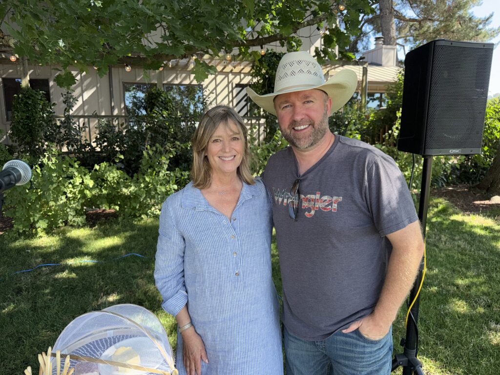Barb O'Brien with musician Zach Neil on the lawn